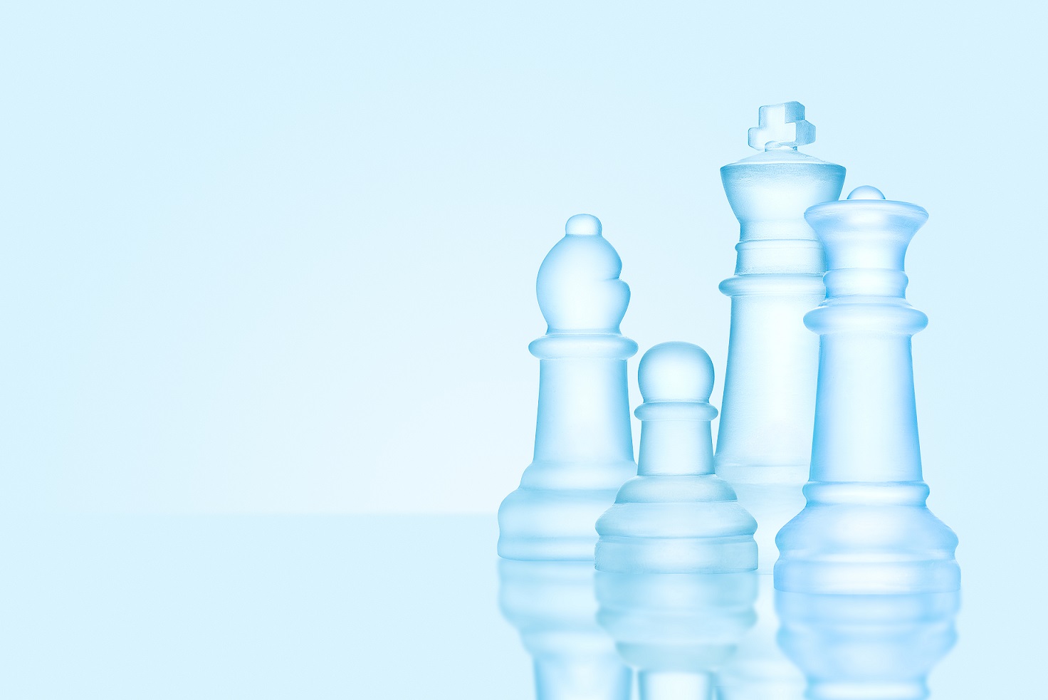 Strategy and leadership concept; frosted chess figures made of ice, standing together ready for game as on a family photo.